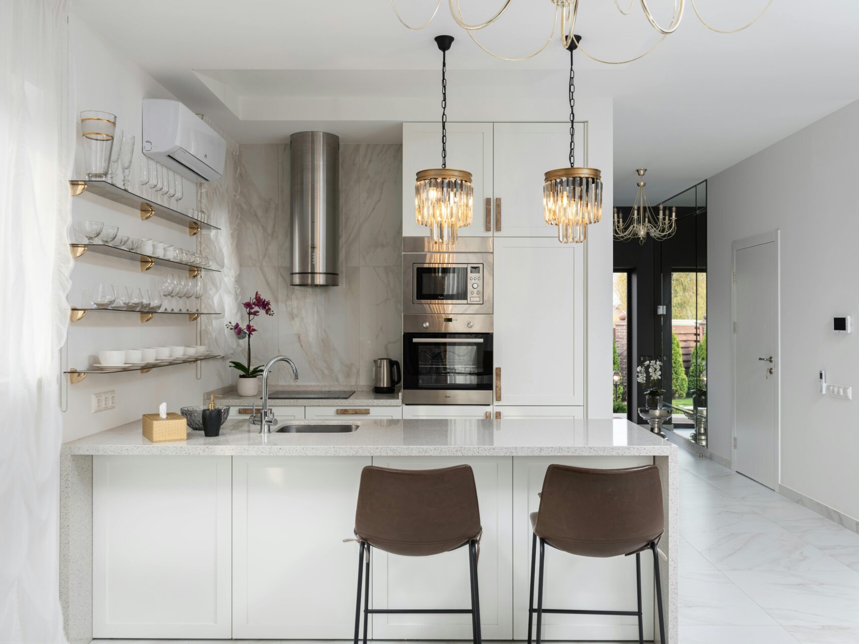 interior of luxury kitchen with marble and chandeliers