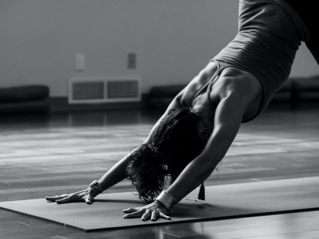 woman posing in a downward dog yoga pose.