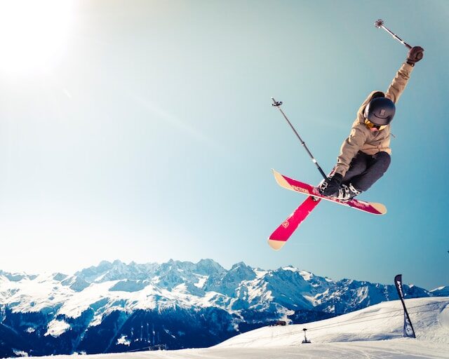image of a person snow skiing on a mountain doing a jump