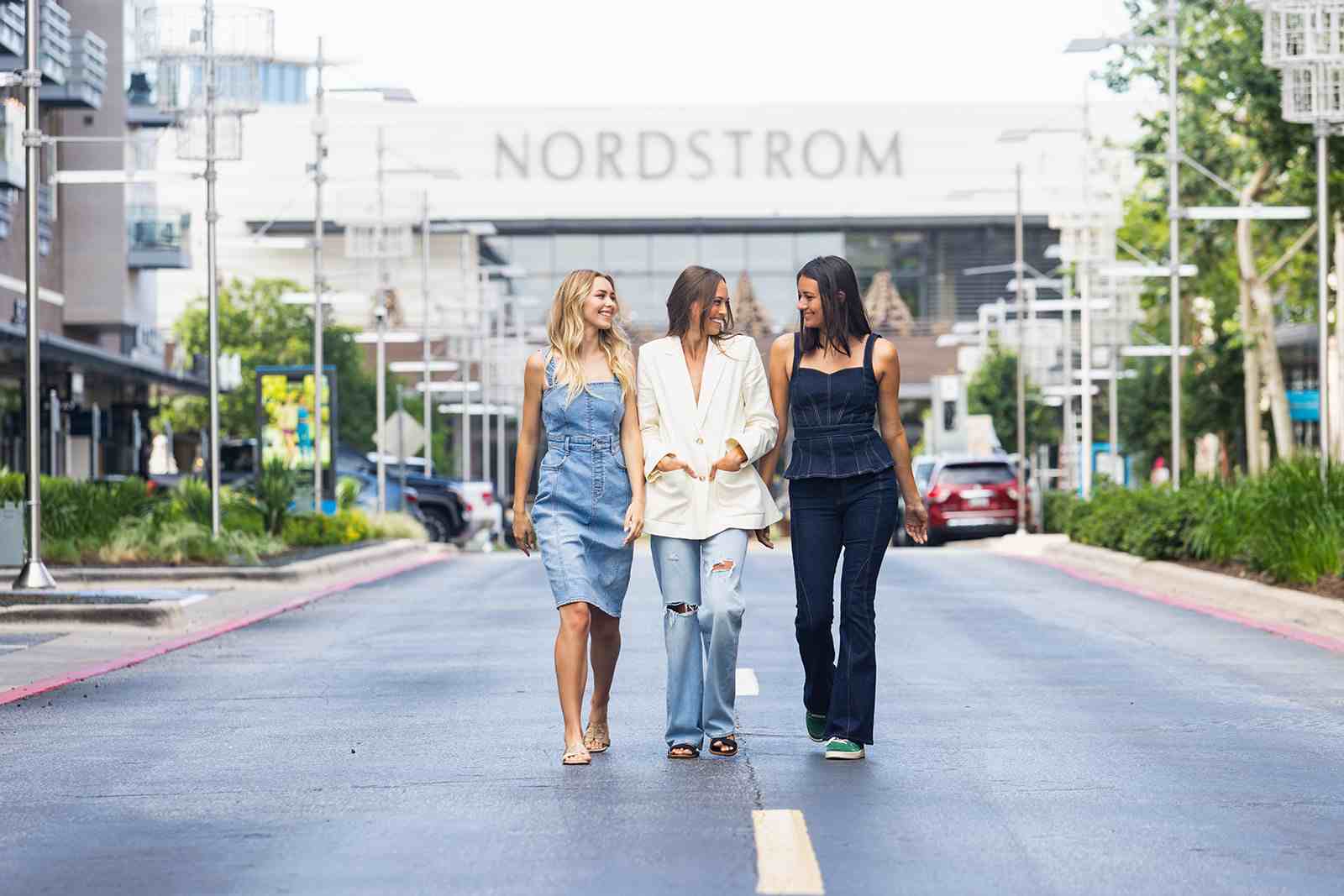 3 Women walking down street in front of Nordstrom building in background for article Austin's Domain NORTHSIDE for newcomers moving to Austin.