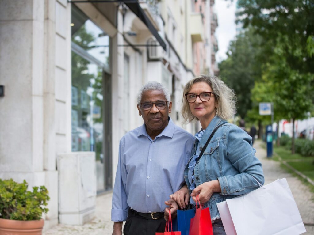 older black man and white woman shopping outdoors