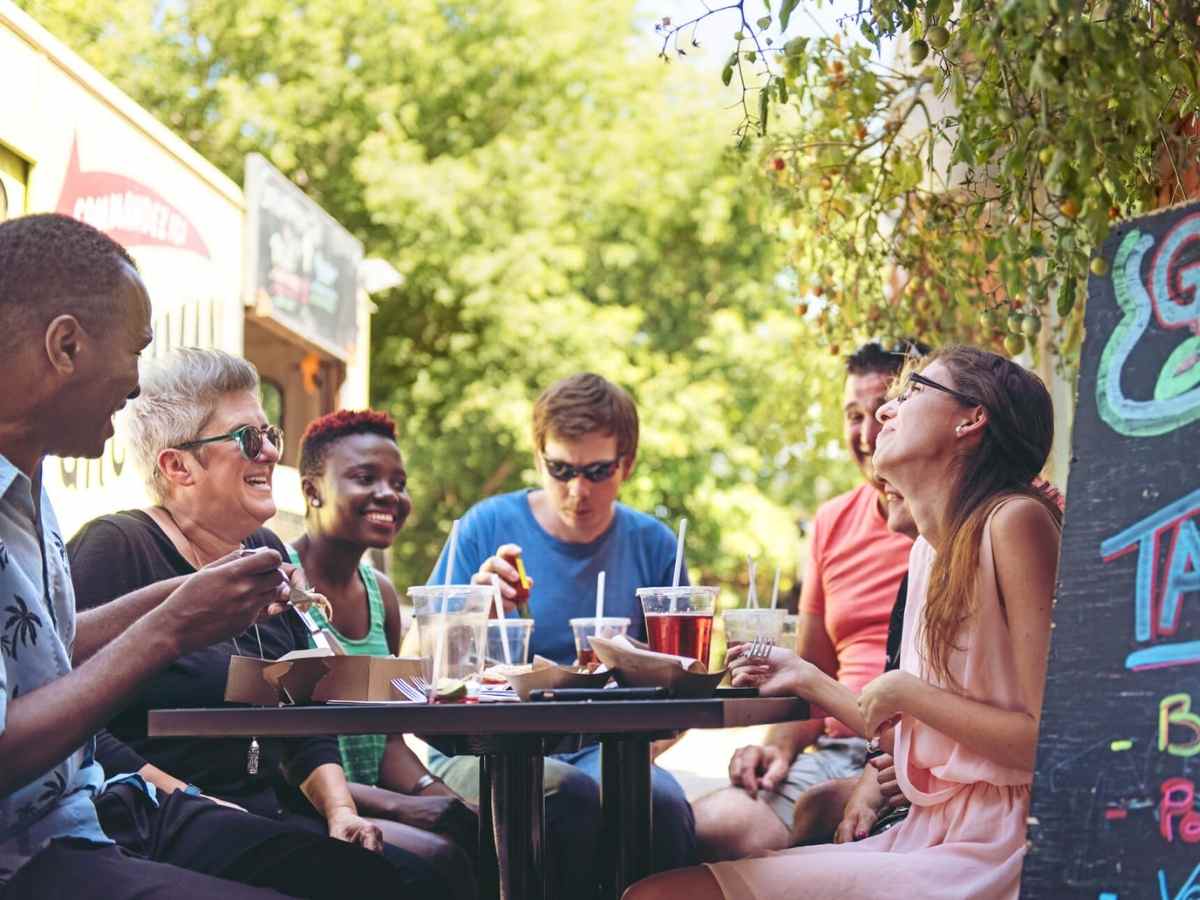 People eating outdoors at restaurant.