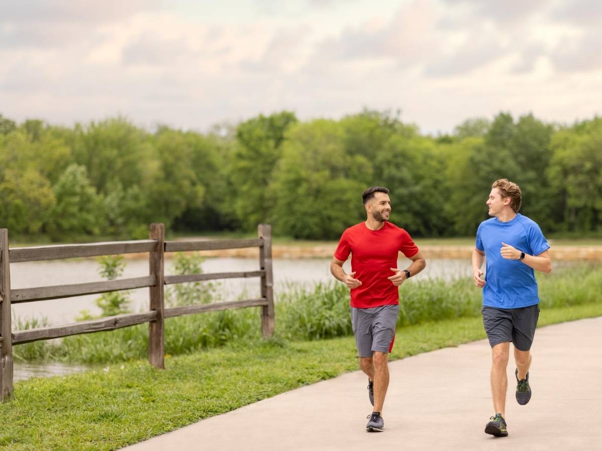 2 people running at Oak Point Park Nature Preserve in Plano, TX.