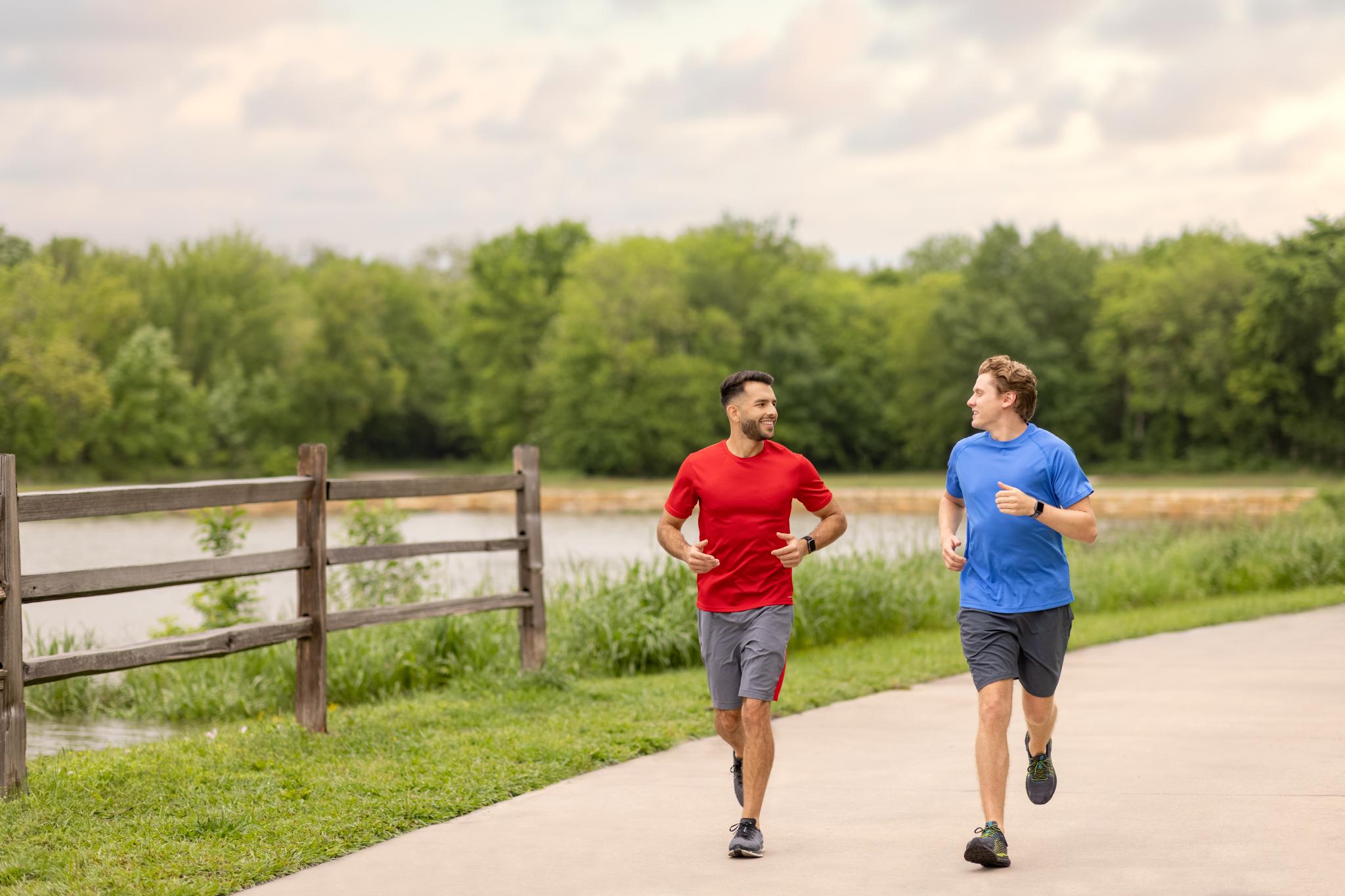 2 people running at Oak Point Park Nature Preserve in Plano, TX.