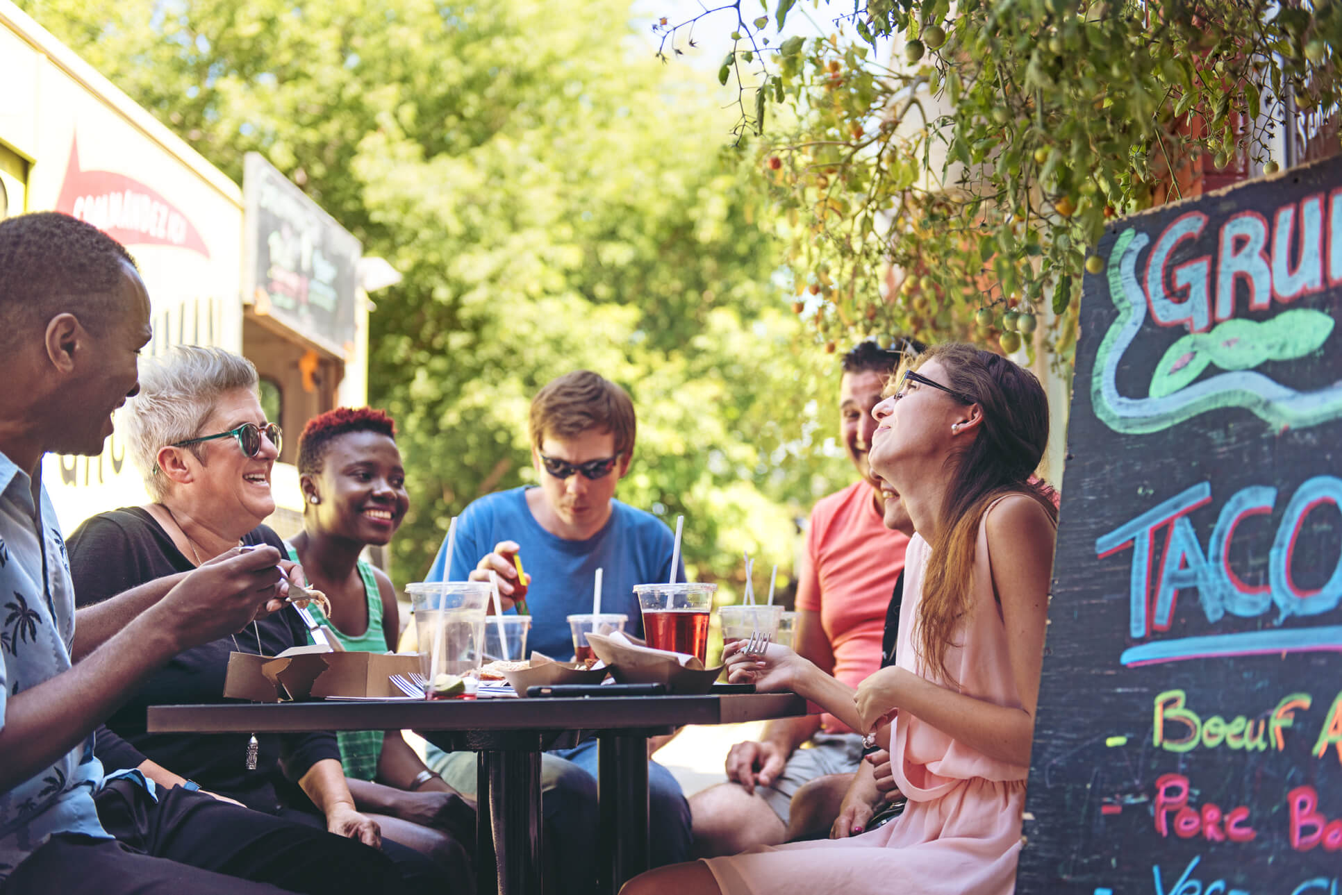 People eating outdoors at restaurant.