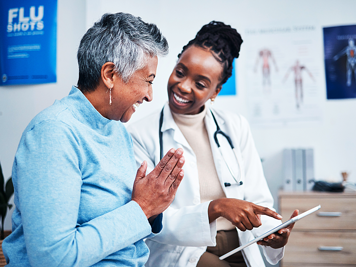 Woman talking with female Doctor for article on Primary Care Physician for newcomers moving to Austin.