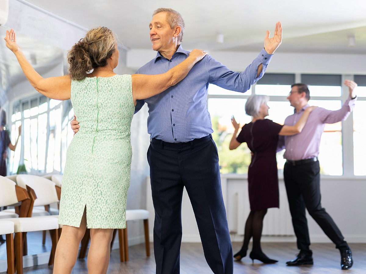 Senior adults learning to dance in a class.