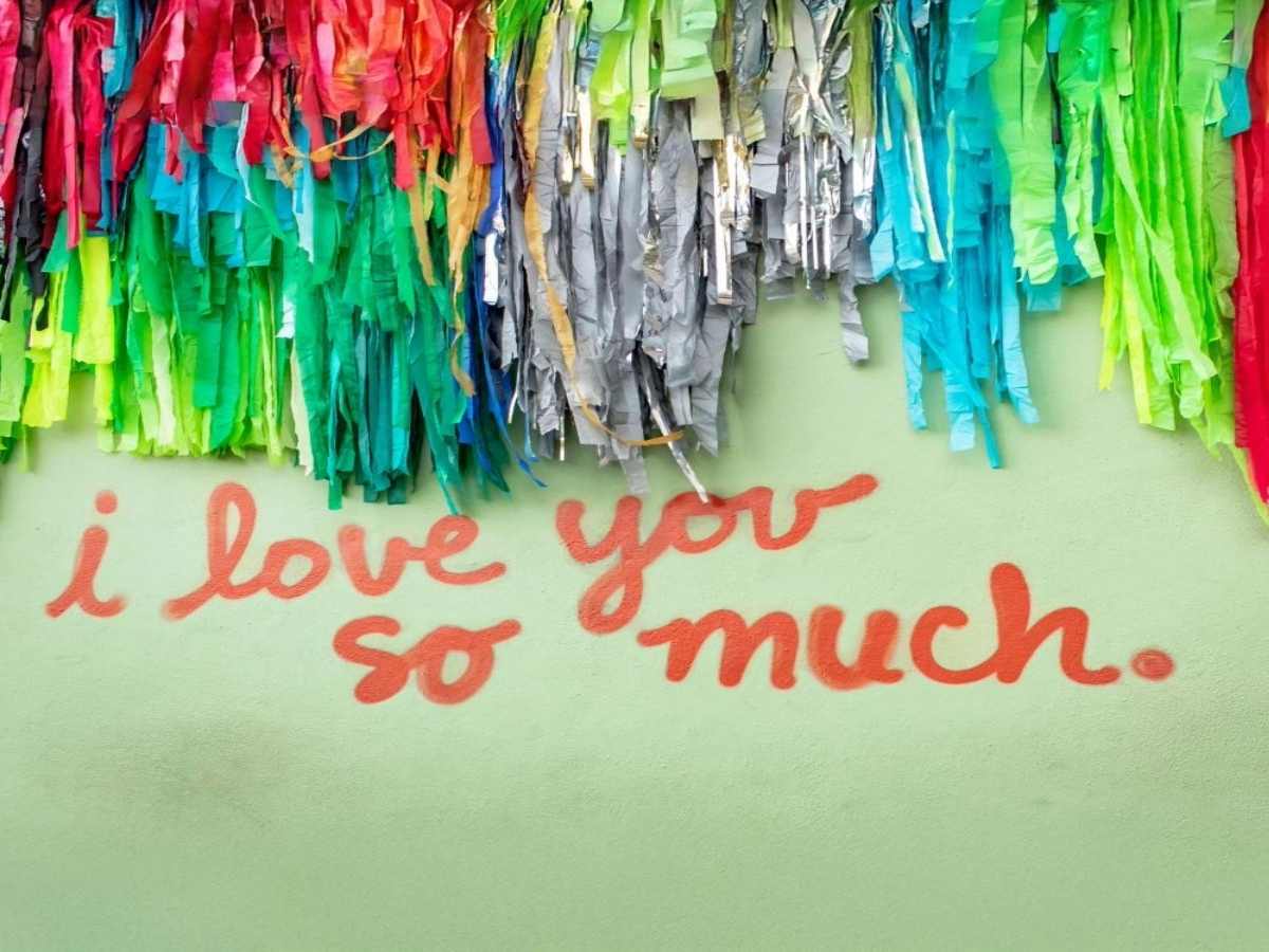 Wall that says I love you so much from South Congress in Austin for article about the most unique neighborhood in Austin for newcomers moving to Austin.