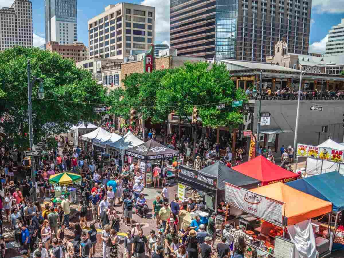 Diverse crowd at outdoor festival in Austin for article Austin Demographic Information for newcomers moving to Austin.