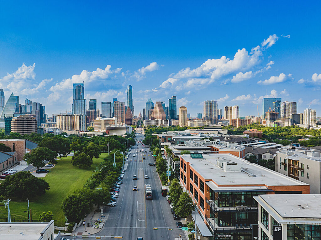 Birdseye view of South Congress with Downtown Austin in the background for article How to Enjoy Austin Like a Local for newcomers moving to Austin.