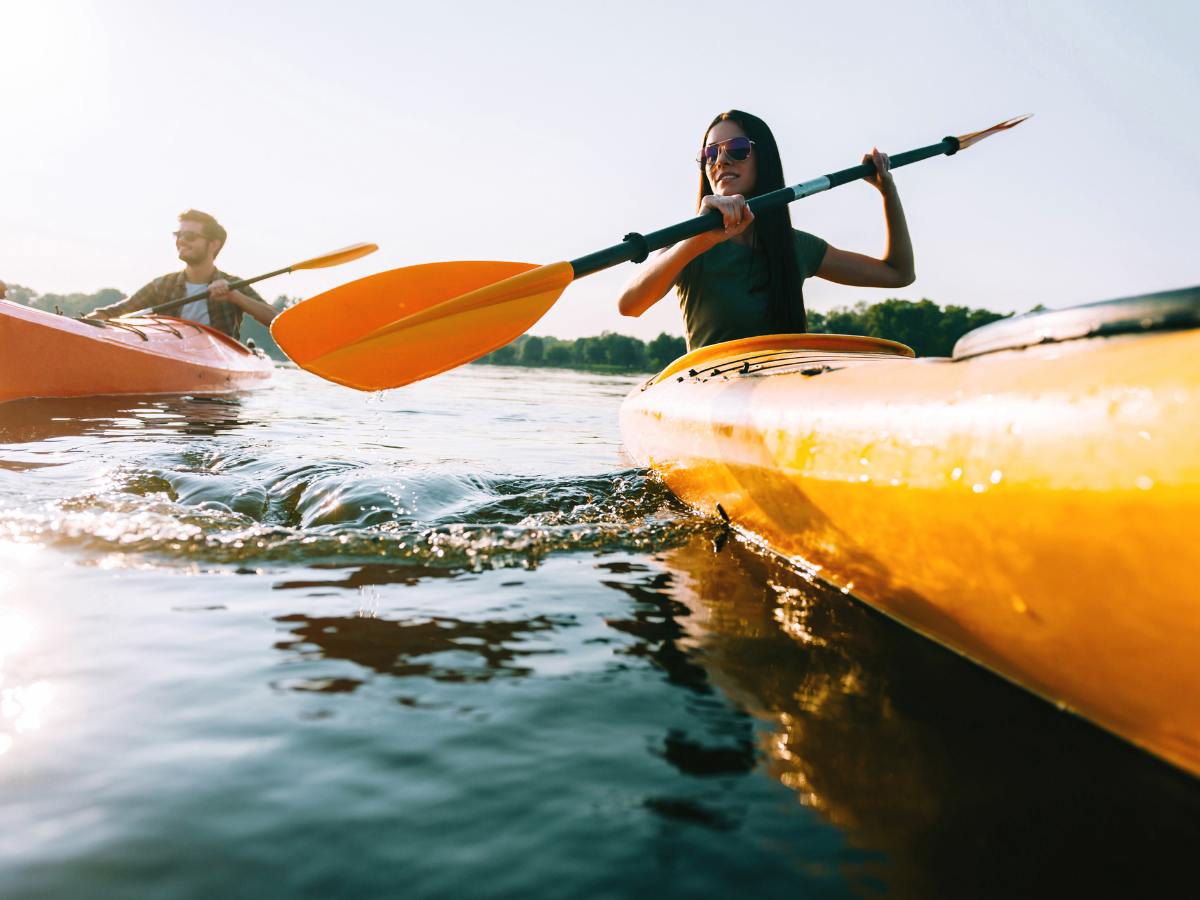 Man and Woman in kayaks on water for article 10 Ideas for A Unique Date Night in Austin for newcomers moving to Austin.
