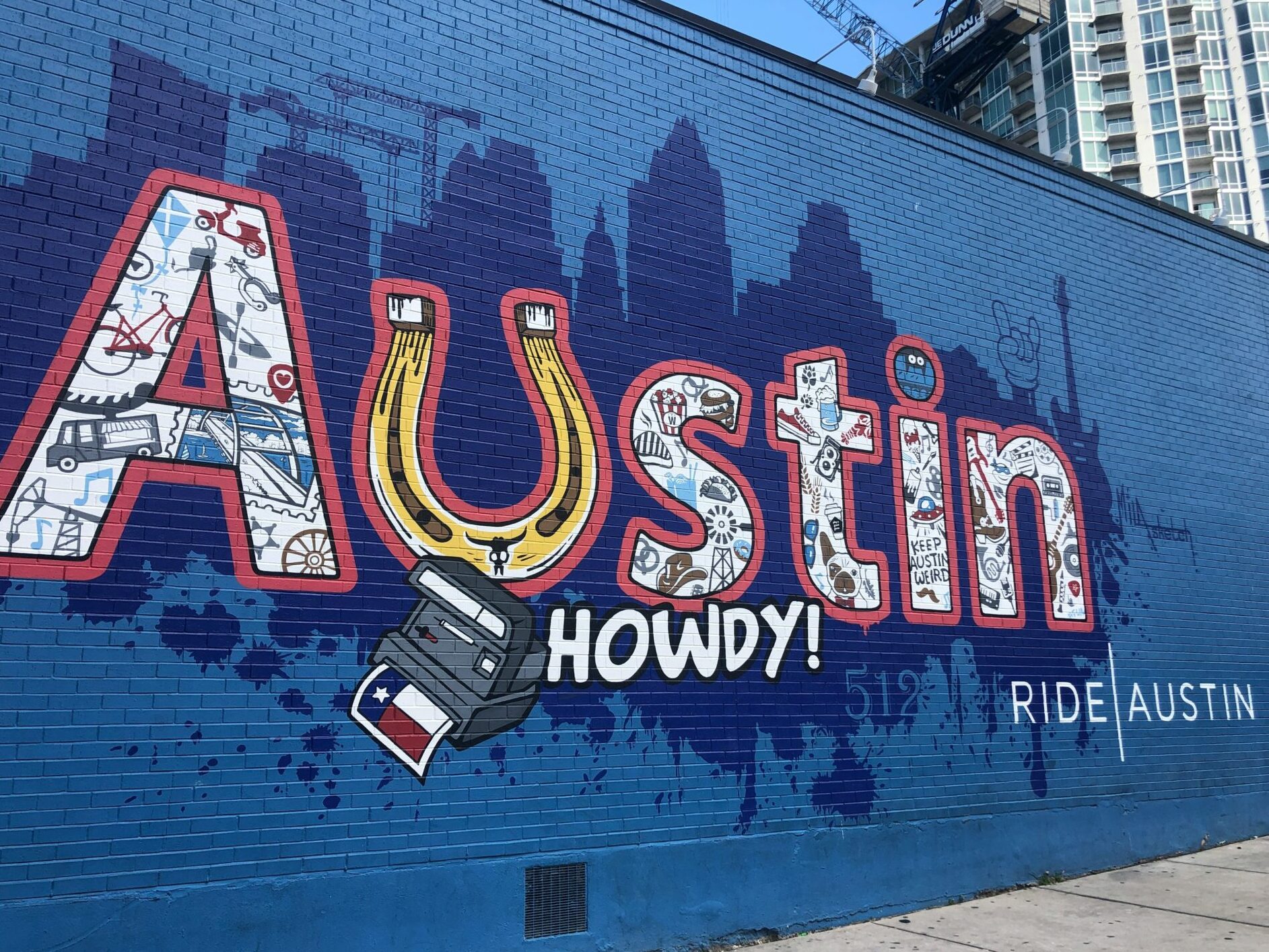 a blue brick wall with a blue building with a blue sky and a building with a blue building with a blue sky and a building with a blue sky - move to Austin